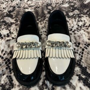 Black and white fringe loafers